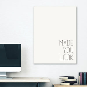 White minimalist canvas wrap wall art hanging on white bedroom wall with funny saying "made you look"