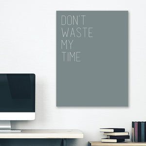 Grey minimalist canvas wrap wall art hanging on white bedroom wall with funny saying "dont waste my time"