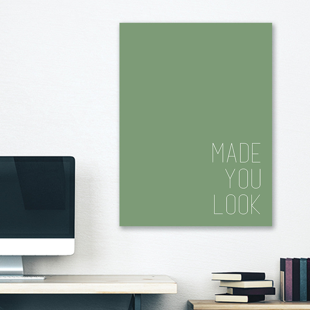 Green minimalist canvas wrap wall art hanging on white bedroom wall with funny saying "made you look"