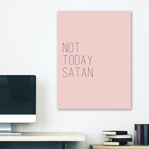 Pink minimalist canvas wrap wall art hanging on white bedroom wall with funny saying "not today satan"