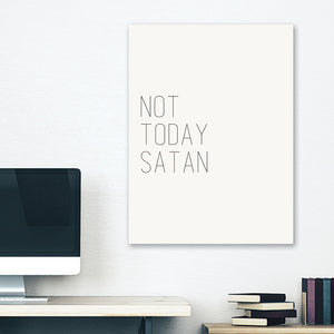 White minimalist canvas wrap wall art hanging on white bedroom wall with funny saying "not today satan"